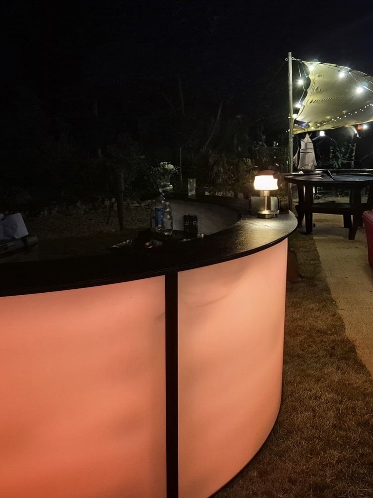 Salute mobile bar lit up at an evening event