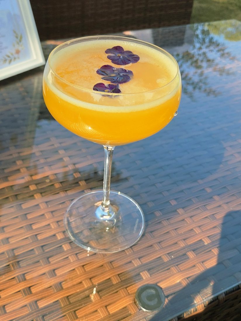 Cocktail with edible flowers served at a Salute event
