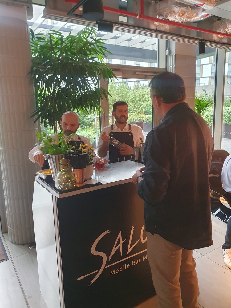 Salute bartenders serving guests at the mobile bar