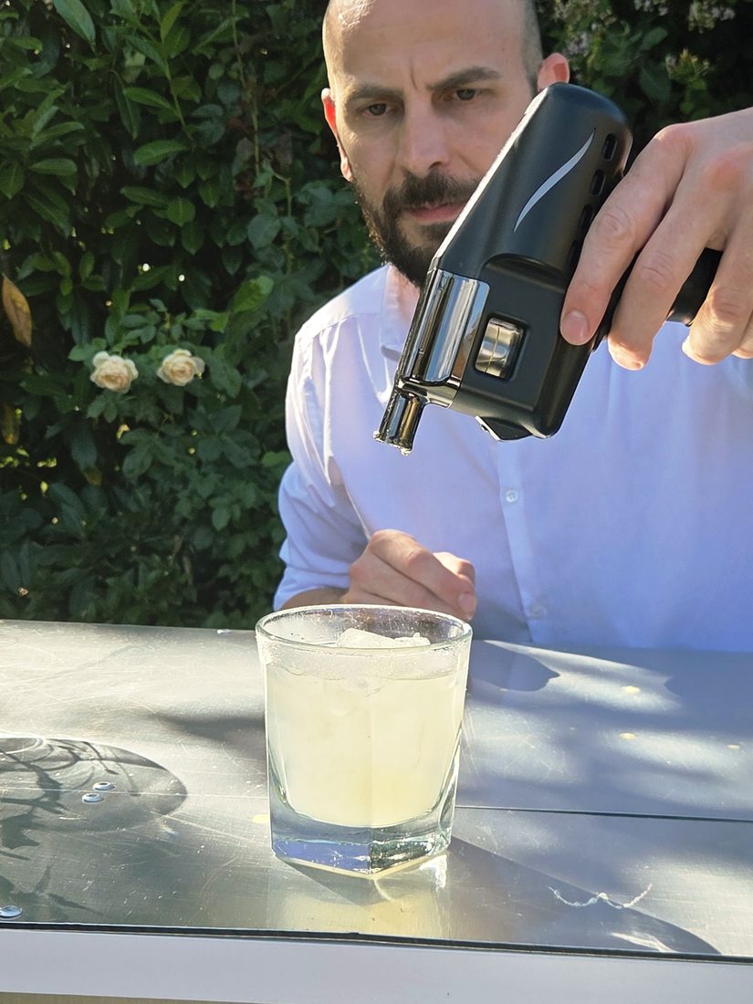 Salute bartender torching a cocktail at an outdoor event