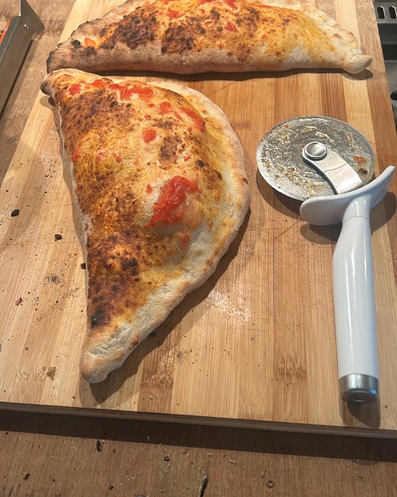 Freshly baked Salute calzone on a wooden board