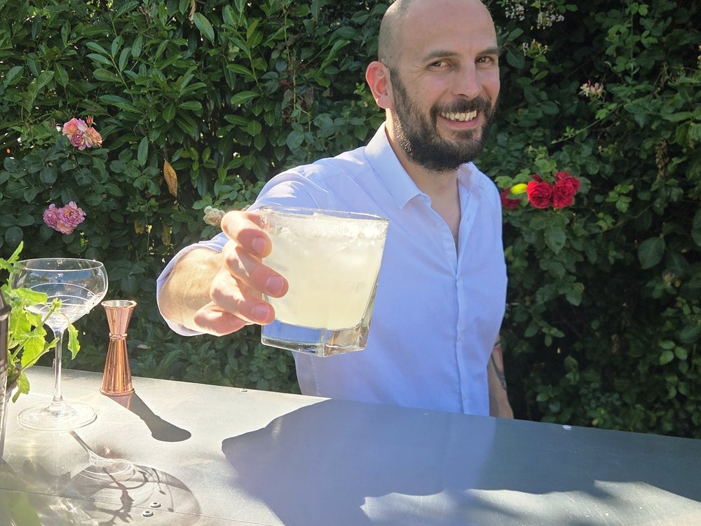 Salute bartender handing over a freshly made cocktail